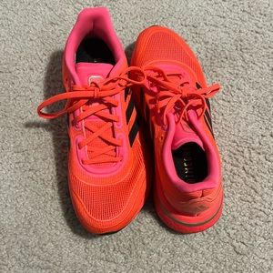 Adidas tennis shoes. Size 7 kids =womens size 8. Hot orange color. Worn twice.
